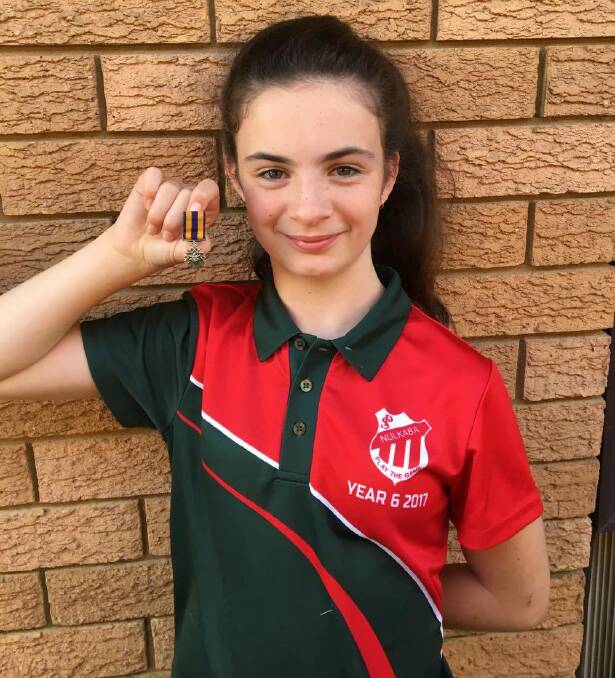 HAPPY ENDING: Chloe Goldstraw with her grandfather's service medal, which was handed in at Cessnock Police Station on Friday after it was lost at the Anzac Day march. Picture: Priscilla Goldstraw