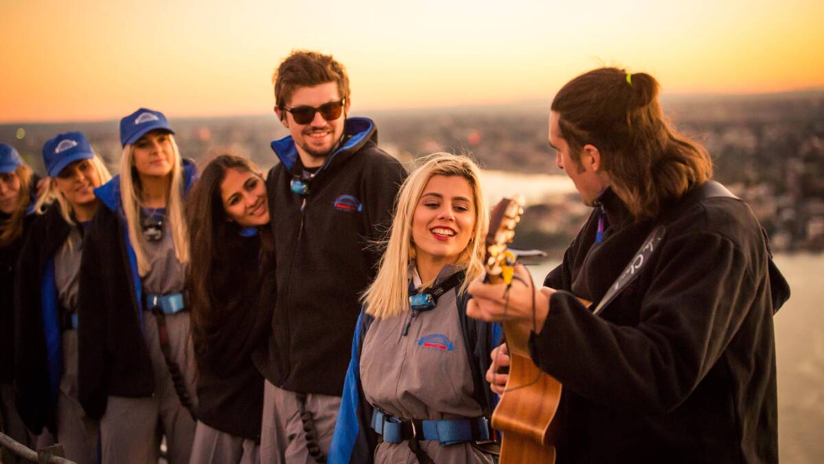 The top of the Sydney Harbour Bridge … climbers greeted by live music.