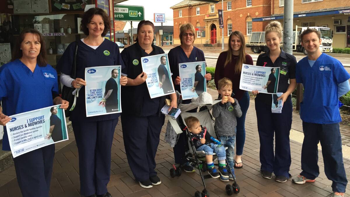 CONCERNED: Branch members of the NSW Nurses and Midwives Association take to Kelly Street, Scone, on Thursday to voice their displeasure at cuts to the health system.