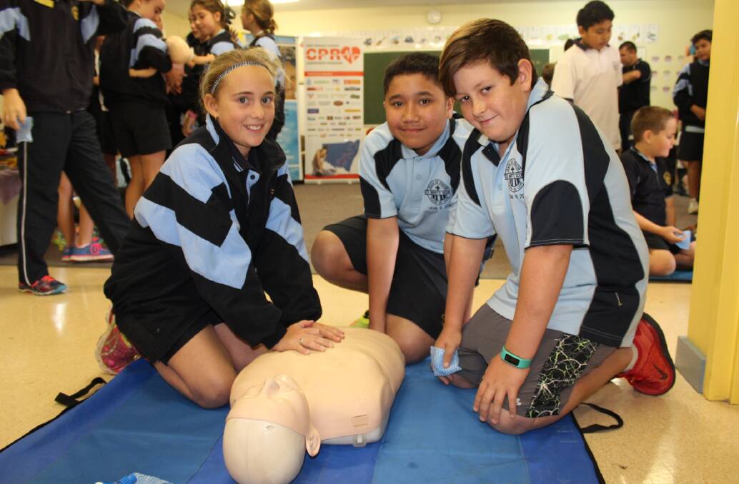 VITAL: St Mary’s Primary School students Georgie McRae, Doarte Ortega and Flynn Carter practice the potentially lifesaving skills of CPR.