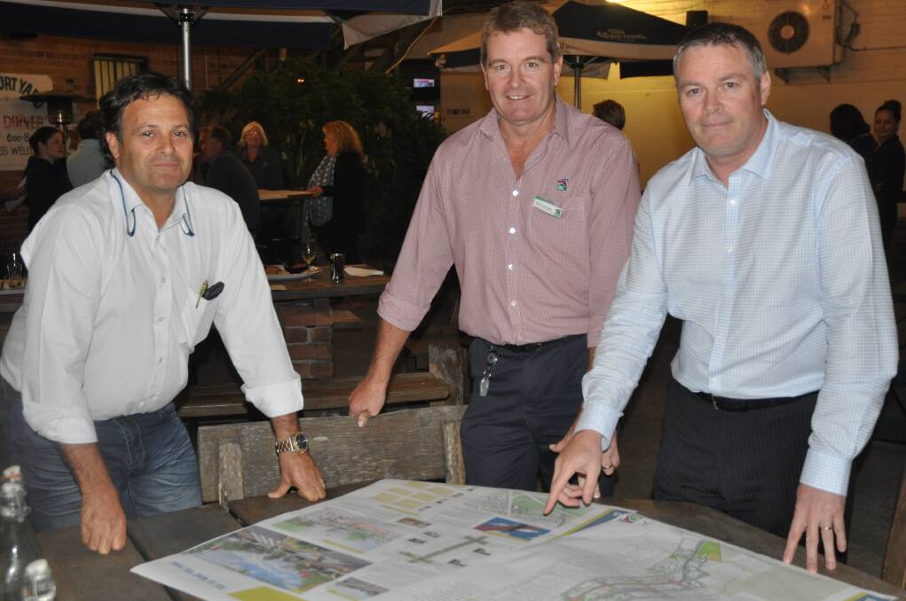 PLANS: Upper Hunter Shire Mayor Wayne Bedggood with Council's Business Enterprise and Tourism manager Sean Constable and General Manager Waid Crockett look over the draft Masterplan for Scone at the Belmore Hotel.