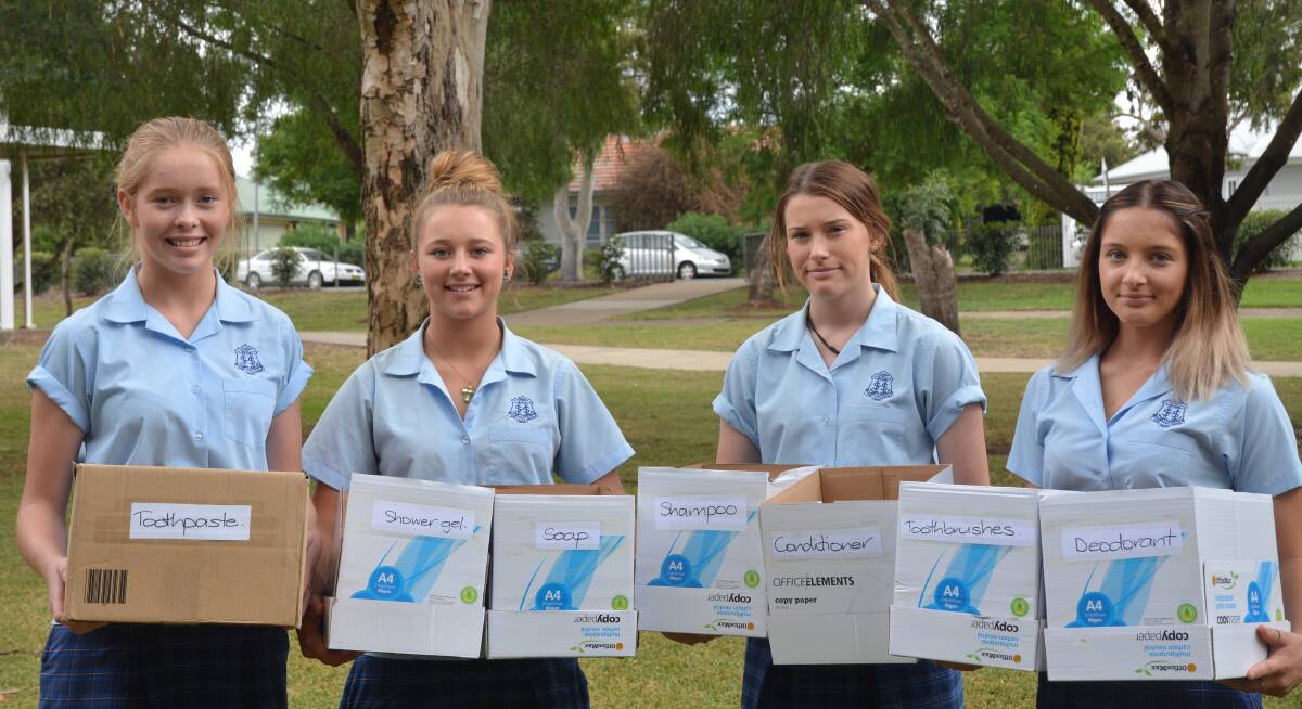 HELPING OUT: Scone High School students Matilda Jones, Tyler Palmer, Darcy Pittman and Jessica Martin with donation boxes on Tuesday morning.