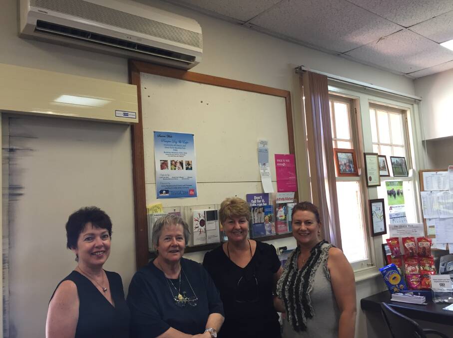 EXPENSIVE: Scone Neighbourhood Centre's Jan Kelaher huddles under the air conditioner with Evelyn Synnott, Lee Watts and Deb Bui on Friday afternoon.