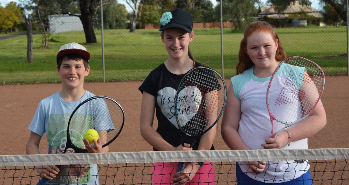 EXCITED: Jimmy Riley, Sarah Riley and Emily Collard enjoying the school holidays at the Parkville Tennis Courts this week.