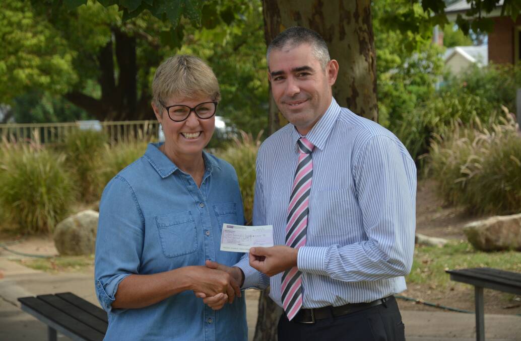 CONTRIBUTION: Where There's A Will's Pauline Carrigan receives a cheque from Scone Grammar School's Reverend Nate Atkinson on Monday.