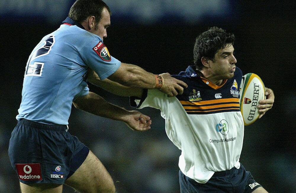 POWERFUL: James Holbeck of the ACT Brumbies holds off Nathan Grey of the NSW Waratahs during a Super rugby match at Aussie Stadium, Sydney, Australia in 2002. Picture: Nick Wilson/Getty Images