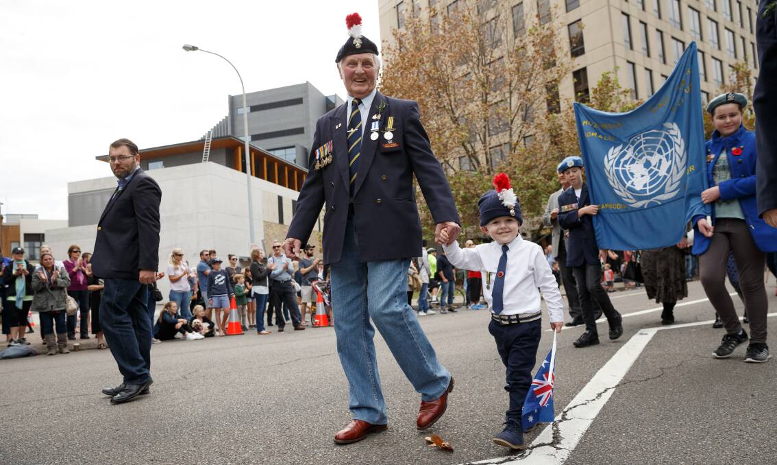 PROUD: Michael Wood from the British Royal Regiment of Fusiliers, marching with his grandson, Eli, 3, during the Newcastle Anzac Day March. PICTURE: Max Mason-Hubers 