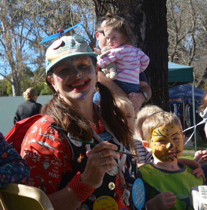 A SPLASH OF COLOUR: Sparkles the Clown being kept busy with face painting at a recent markets day in Scone.