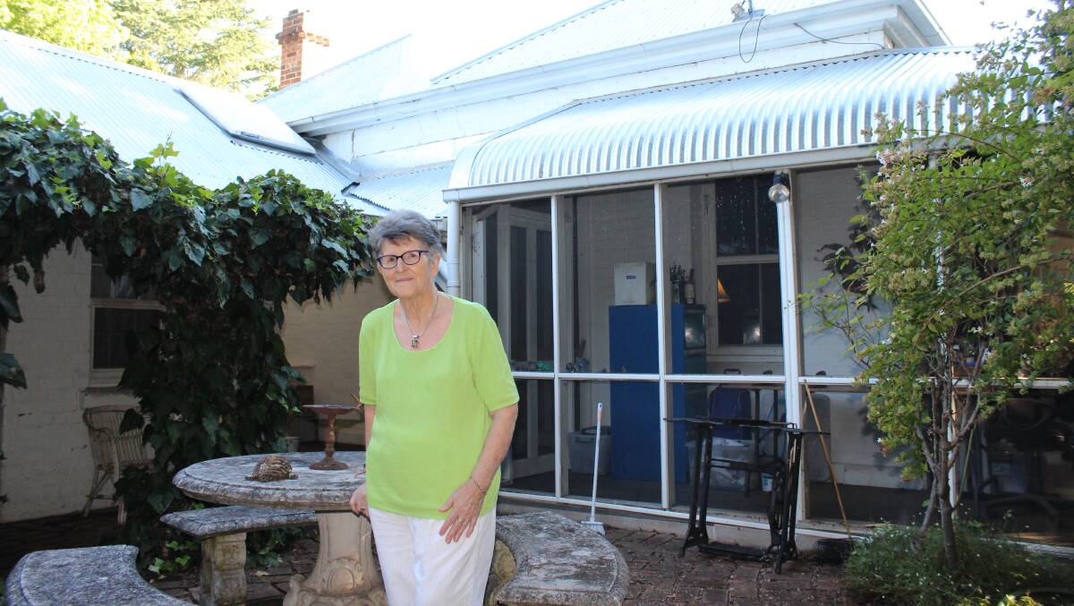 VERY PLEASED: Artist Jean Davies used galvanised corrugated steel to replace the roof on her 1870s home after the 2016 hail storm in Murrurundi.