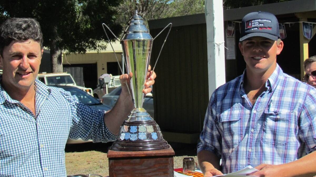 WINNERS ARE GRINNERS: Bill Davidson with the winner's cup flanked by Murrurundi Sheep Dog Trials president Tom Hunt.