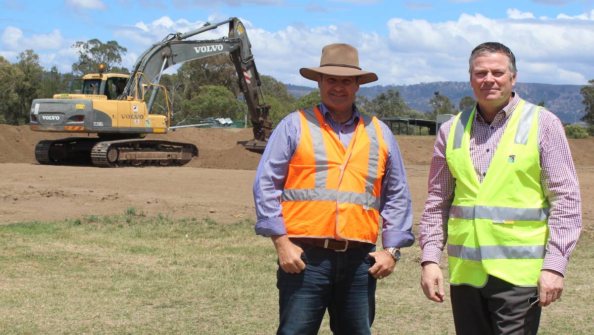 UNDER CONSTRUCTION: Upper Hunter mayor Wayne Bedggood and council’s general manager Waid Crockett inspect the start of ground work for the new all-weather arena being built at White Park in 2018.