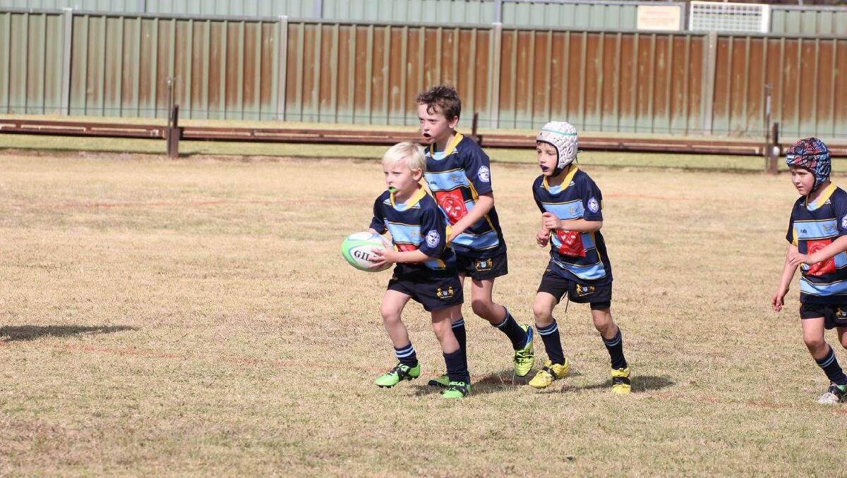 BARNSTORMING: Eddo Dawson leads the Scone under-8 pack at the weekend.