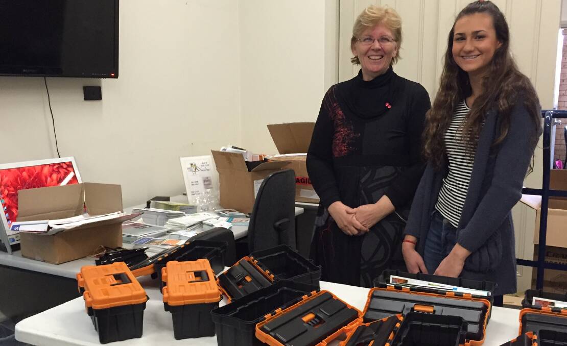 THE RIGHT TONIC: Belinda McKenzie and Hannah Rando pack tool boxes to be distributed at doctors’ surgeries across the Upper Hunter.