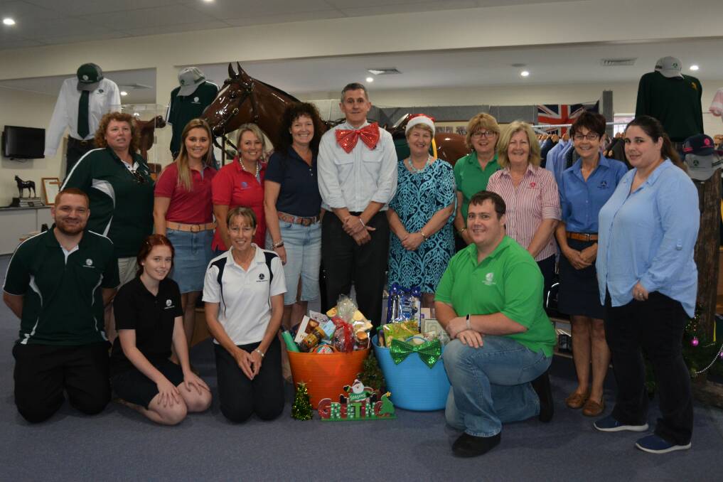 FEELING JOLLY: The Australian Stock Horse Society employees with Scone Neighbourhood Resource Centre's Lee Watts.