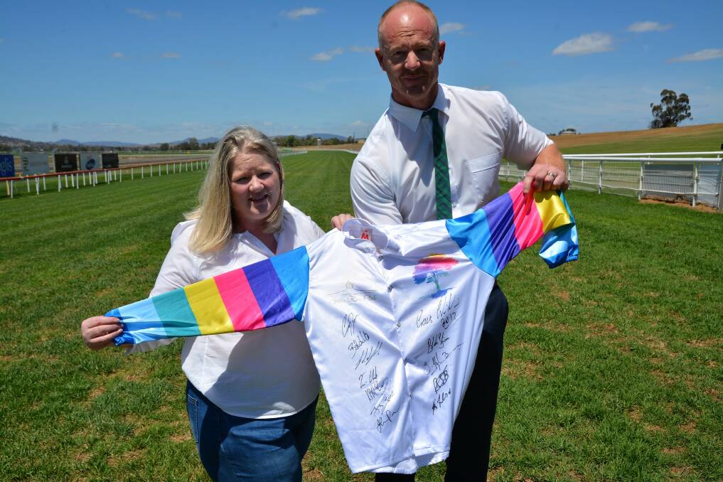 Where There's A Will's Andrea Burns and Scone Race Club CEO Heath Courtney with the silks signed by The Everest jockeys on Saturday.