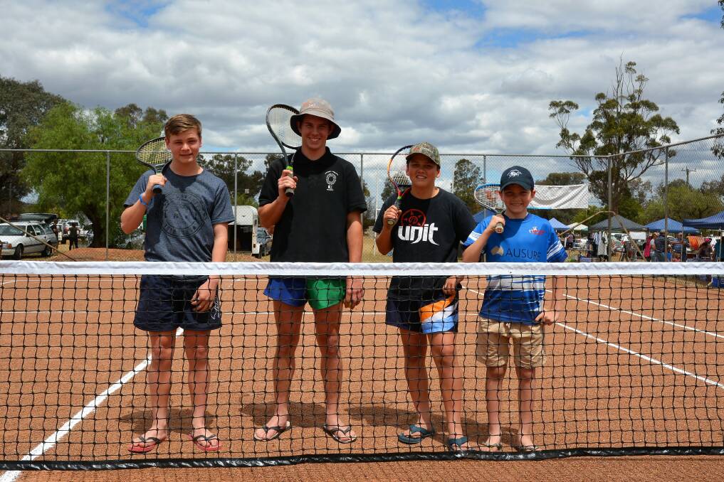 FUN ON COURT: Alex Dahmes, Richard Riley, Thomas Dahmes and Henry Dahmes at the Parkville Tennis Courts on Sunday.