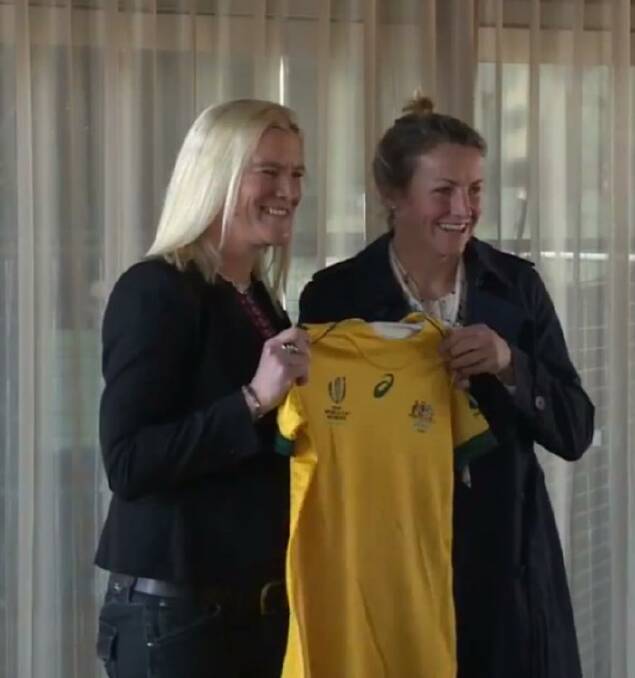 GREEN AND GOLD: 1998 World Cup captain, Nickie Wickert presented Kate Brown with her jersey in Sydney yesterday.