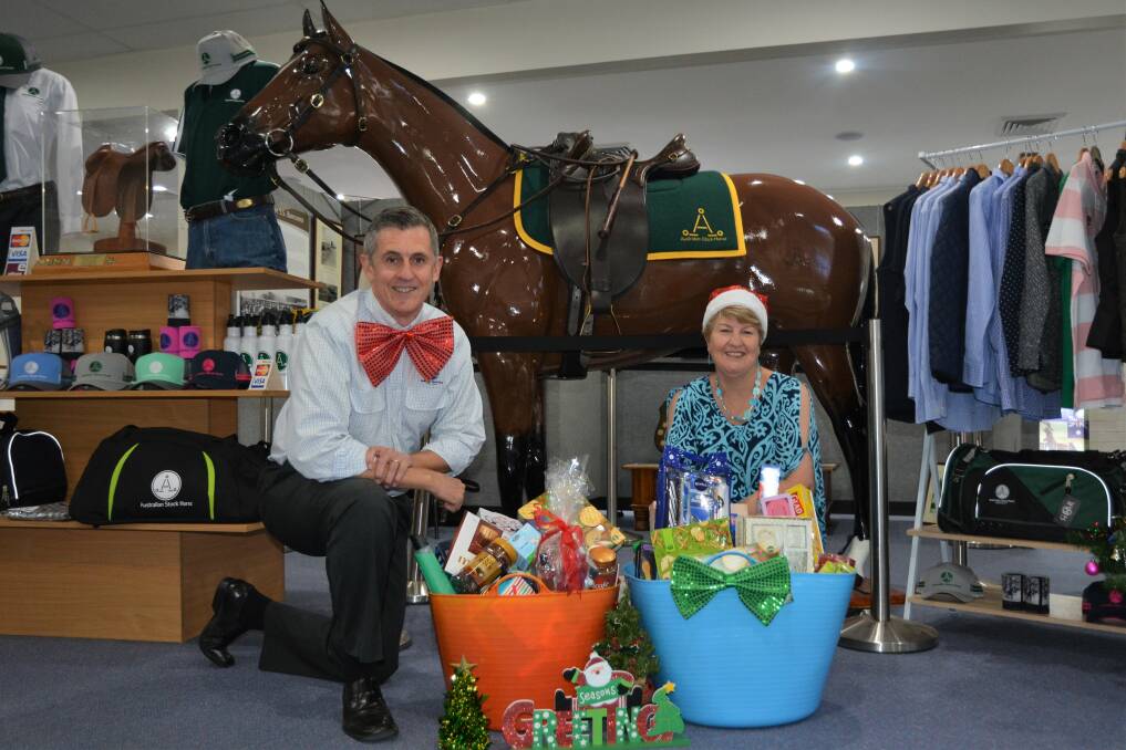 FESTIVE SPIRIT: Australian Stock Horse Society general manager David Gatwood and Scone Neighbourhood Resouce Centre's Lee Watts with the donated hamper items.