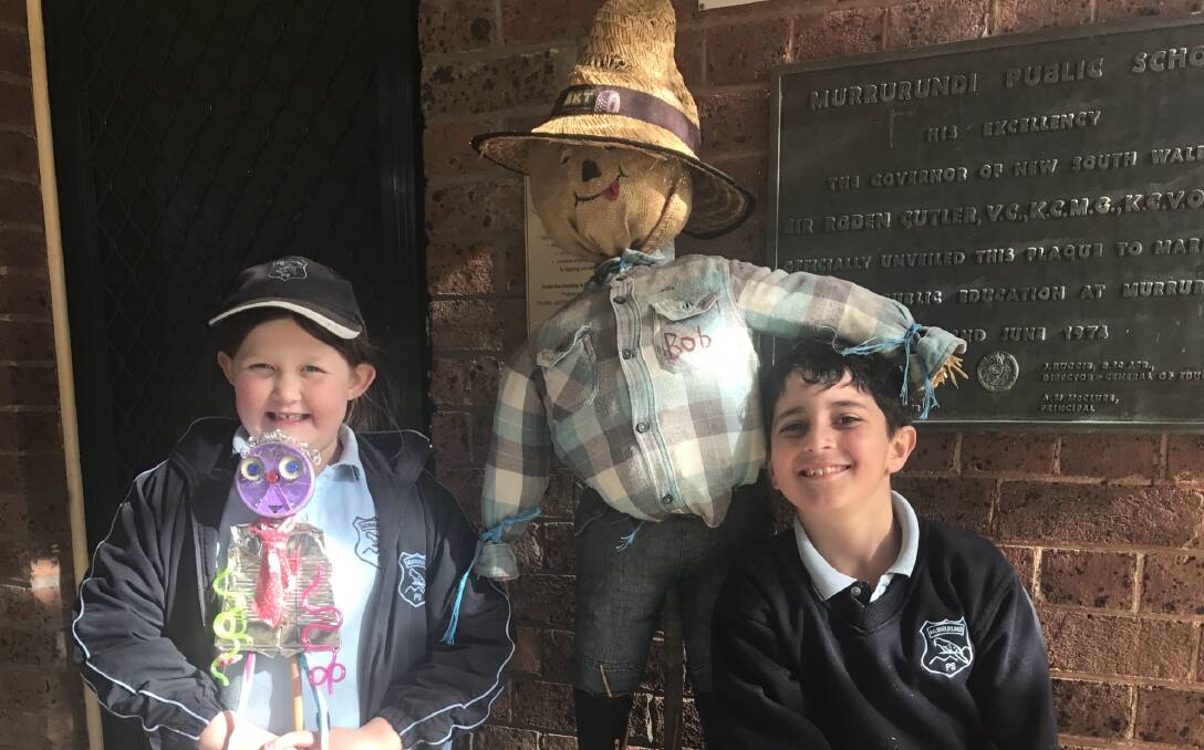 JOIN THE FUN: Ally Sevil and Ahmad Challak with two Scarecrows from previous years.