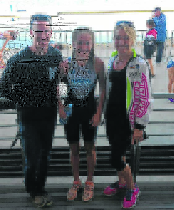 Triathlete Chloe Hollingsworth (centre) with her coaches Chris Stevens and Nicky Western.