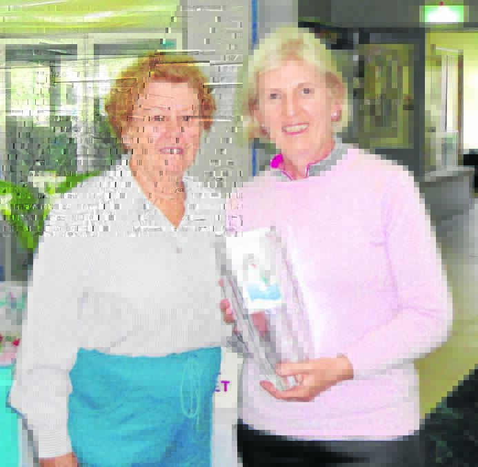 Ladies Golf Open Championship Division 2 winner Ruth Wallace (right) receiving her trophy from Jan Williams.