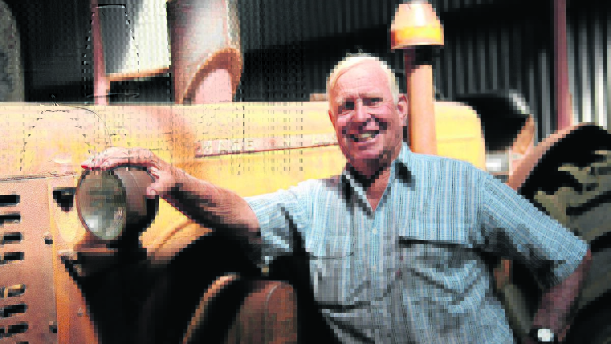 Merriwa Men’s Shed president and Seniors Award winner Jim Alker stands alongside one of his ‘labour of love’ restoration projects, a 1950 Chamberlain tractor. 