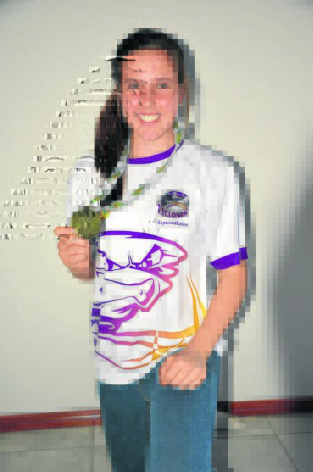 Scone junior cricket star Kirsten Smith with her winning medal from the Australian Junior Indoor Cricket Championships in South Australia.