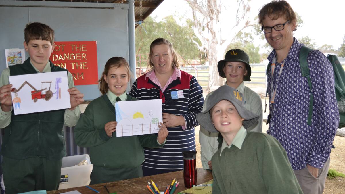 Designing Farm Safety Day posters with program coordinator Georgie Fairfull and St Joseph's Primary teacher Mark Morris were students John Magner, Jemma Grady, Nicole Martin and Charles Brazier.