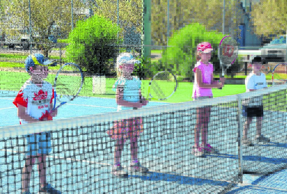 Local children Max Patterson, Violet Dawson, Harriette Firth and Walter Yuille practicing their tennis positions.
