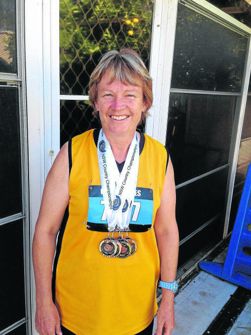 Aberdeen senior athlete Jeannie Seymour with the medals she won at the Amateur Athletics NSW Country Championships.
