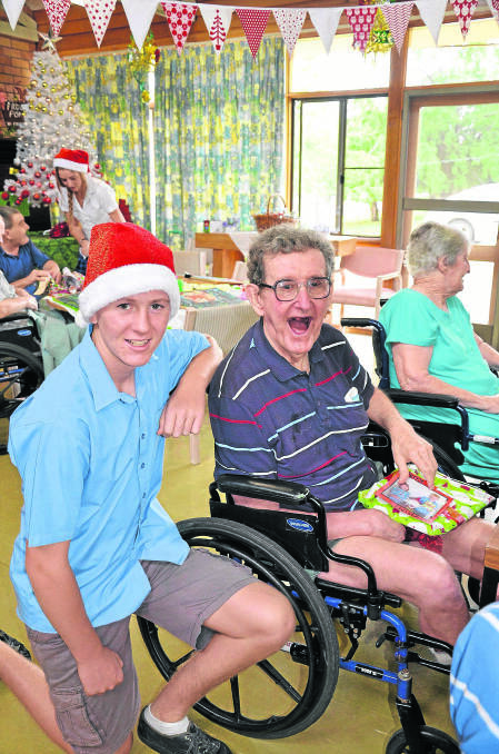 Scone High School’s Lachlan White brightens the face of Strathearn resident Joey Power when he gives him a gift. 