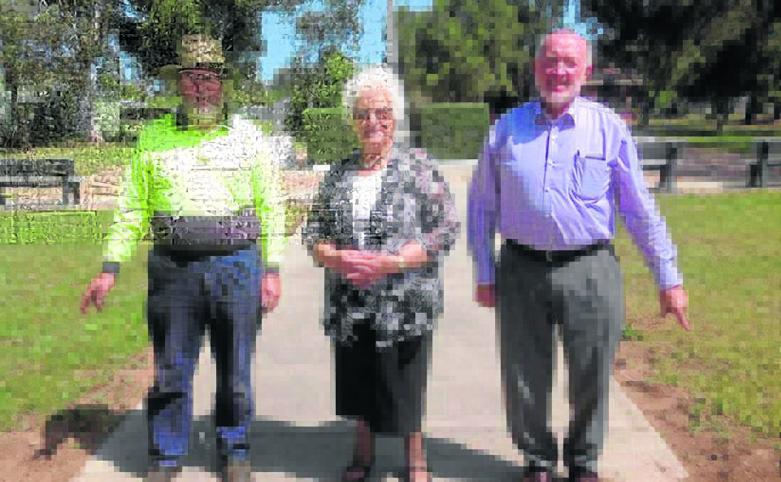 Upper Hunter Shire Council parks and gardens officer James Constable, Merriwa Red Cross liaison officer Philomena Constable and Upper Hunter Shire councillor Ron Campbell in front of the roses at the cenotaph planted this month to commemorate 100 years of the Red Cross in Merriwa.


