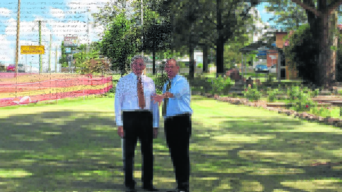 Member for Upper Hunter George Souris and Upper Hunter Shire mayor Michael Johnsen inspecting the bad corner where the accident occurred last week.