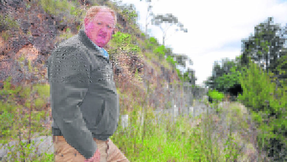 Upper Hunter Shire deputy mayor Maurice Collison shows the cutting and river bank where work started this week to make it a safer thoroughfare for motorists. 