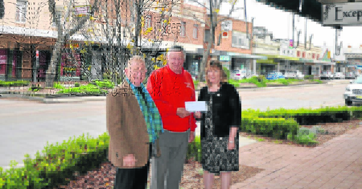 Aberdeen Highland Games vice president Charles Cooke and treasurer Liz Birch donate funds to the Westpac Rescue Helicopter Service Scone Support Group chairperson Errol Bates (centre). 