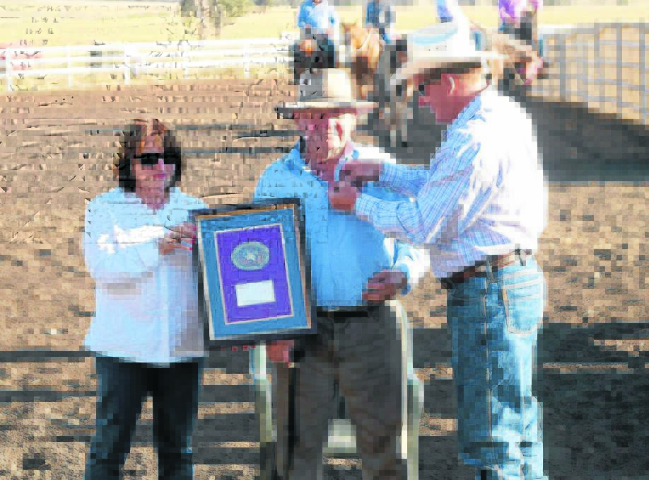 Well known horseman and Bunnan community member Ken Brown (centre) is presented life membership of the Australian Bushman’s Campdraft and Rodeo Association by president Greg Frewin, watched on by his daughter Jan, at the Bunnan Campdraft on Saturday.