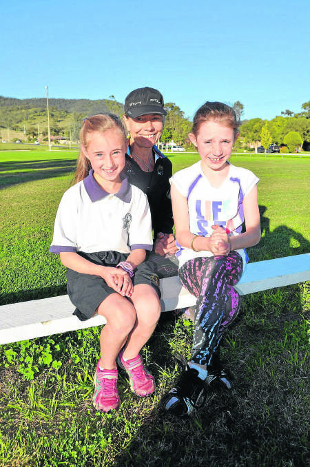 State representative cross country athletes Milly McRae and Millie Crowe with their coach Nicky Western (centre). 