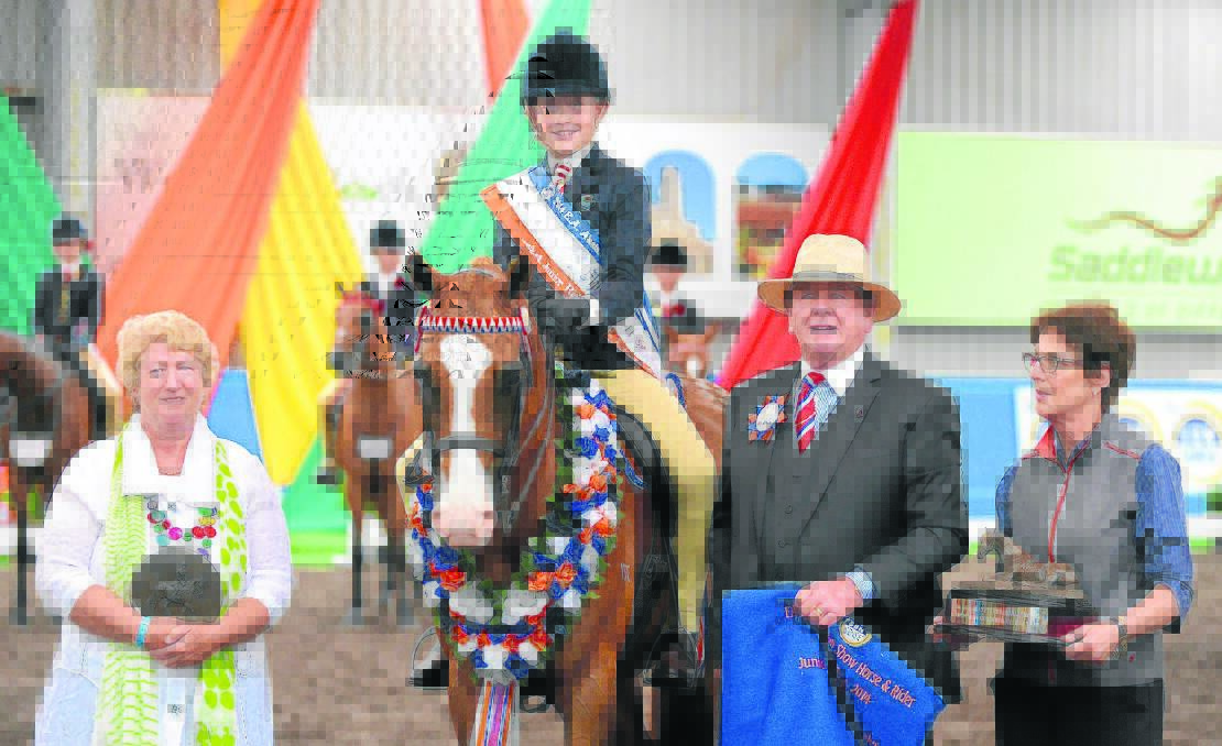Judges Nicole Jamieson (Queensland), Warren Pratley (NSW) and Helen Burns (Victoria) presenting Brendan Kelly with his champion sash and trophies at the Equestrian Australia National Show Horse Championships at Werribee National Equestrian Centre in Victoria.