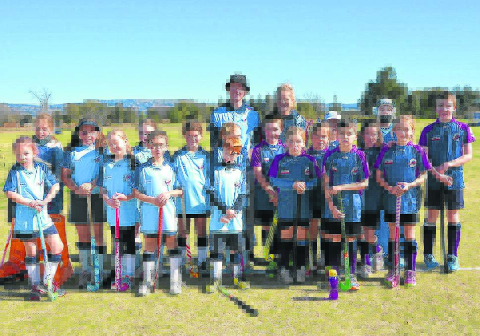 Hockey NSW coaches Isaac Farmilo and Alice Arnott (back) with the Ray White and Scone Muswellbrook Toyota under 11s teams. 