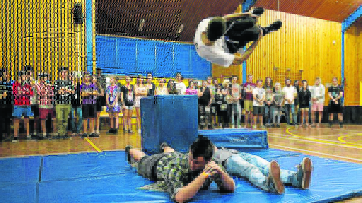 Local youth look on as Clyde Vaughan showcases his Parkour moves, with the help of friends Daniel O’Brien and Angus Hobbs-Haigh, at the recent Youth Beat Music Festival at Scone High School. 