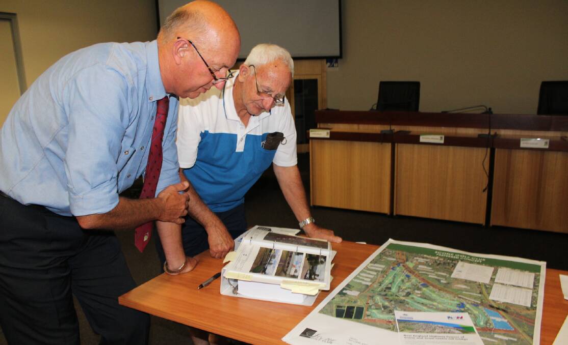 STUDYING: Council’s Director of Infrastructure Services Alan Fletcher and David Spencer view the RMS bypass design.