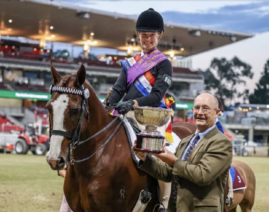 CHAMPION: Scone's Olivia Thrift receiving the George D Scales Memorial Perpetual Trophy at the 2022 Sydney Royal Easter Show. Picture: Supplied