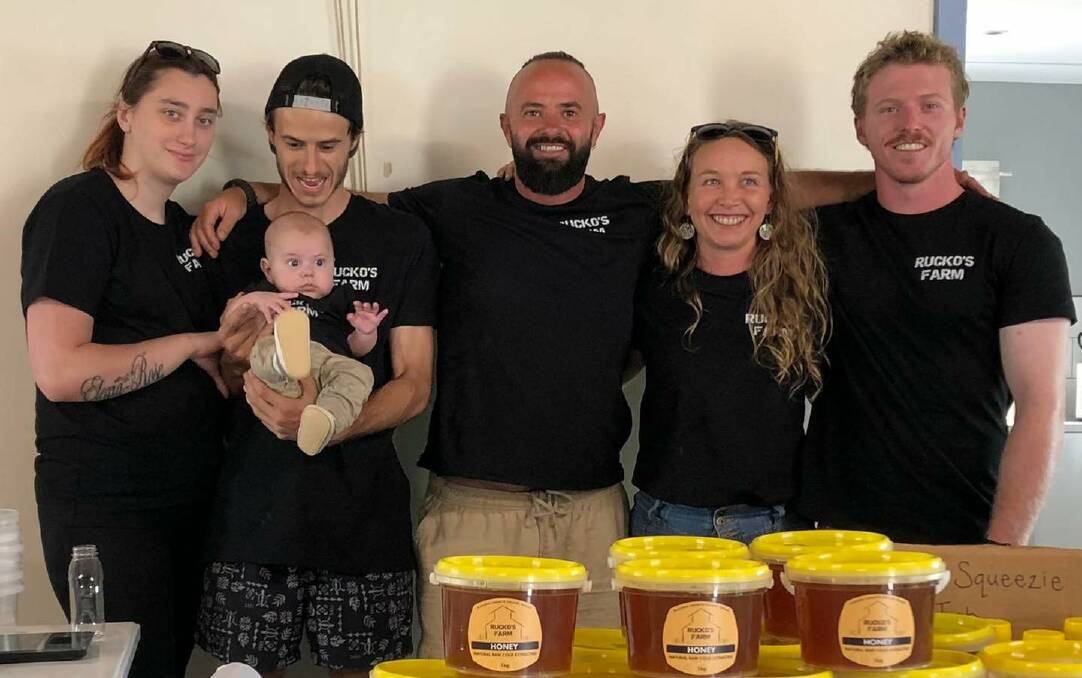 BEEKEEPER: Brett Ruxton (centre) operates 20 bee hives in the Muswellbrook region producing organic honey and beeswax lip balms. Picture: Supplied
