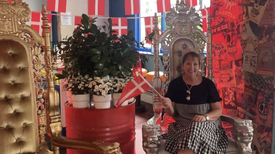 Visitor to the Slip Inn in Sydney enjoying the Danish Coronation festivities sitting in the decorative throne. Picture by Brianna Hedges