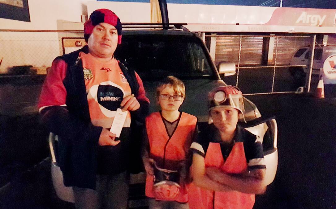 Colin Coady, from Scone, with two of his children and his parking fine after the game. Picture: Helen Coady