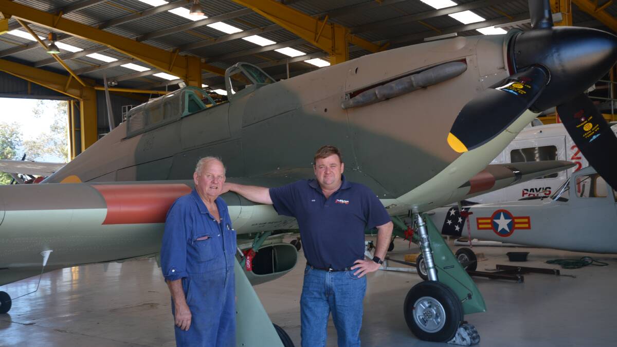 HISTORIC: John Brooks and Ross Pay stand next to Hawker Hurricane 5481 at Scone Airport on Monday.