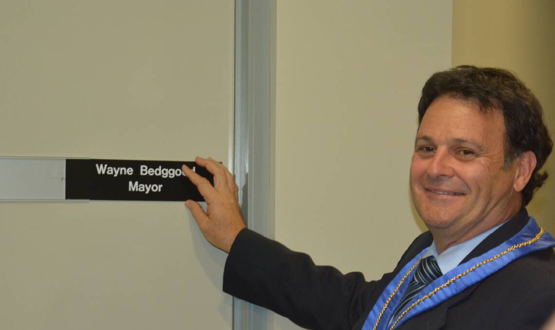 RETURNING: Wayne Bedggood puts his name back on the door after being elected as mayor of Upper Hunter Shire Council on Monday night.