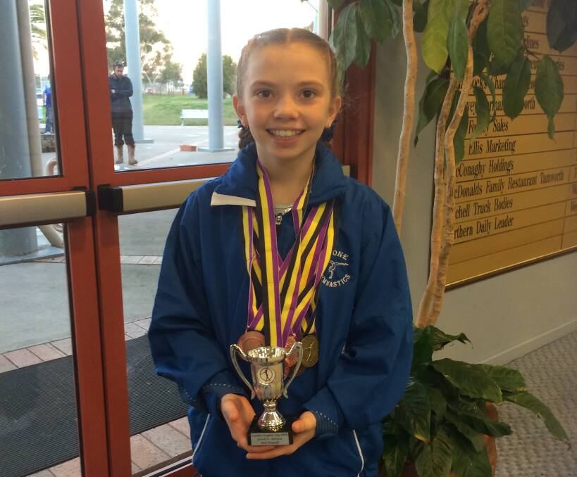 WELL DONE: Riana Tillemans with the trophy and medals she collected at the Country Capital Cup.