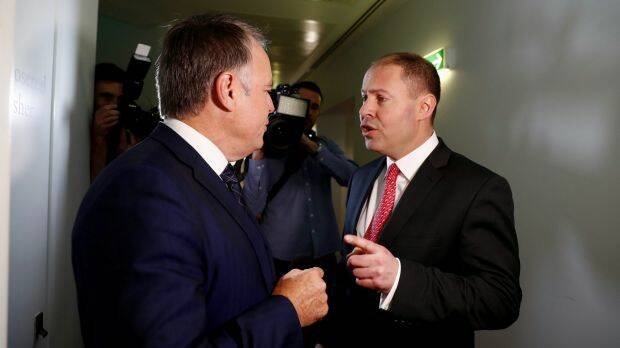 Environment and Energy Minister Josh Frydenberg has an argument with Labor MP Joel Fitzgibbon on energy issues as they cross paths at Parliament House. Photo: Alex Ellinghausen