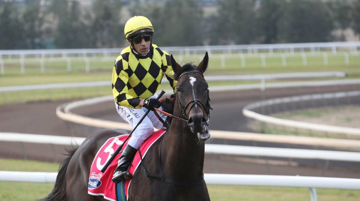 Outburst and jockey Jeff Penza after their win on Tuesday. Picture: Scone Race Club
